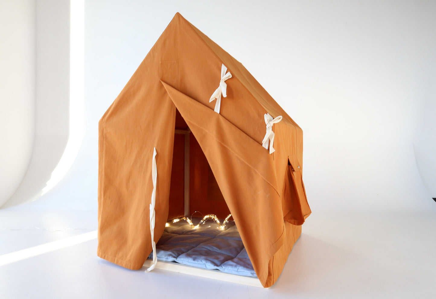 Big mustard-orange playhouse with Scouts emblem and mat